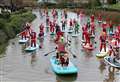 Flotilla of Santas drift in to town