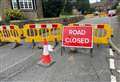 Road closed after manhole sinks into ground