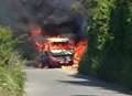 Firefighters tackle burning mini bus