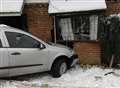 Car ploughs into house