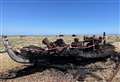 Photographed beach boat is gutted by fire