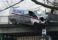 Van hangs over bridge after railings crash