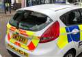 Police car smashed up in daylight attack