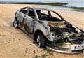 Burnt-out car abandoned at seafront beauty spot