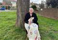 Disabled nan sits under tree to stop it being chopped down