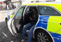 Man poses for pictures in unlocked police car 