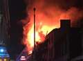 'Arson' arrest after shops inferno