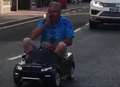 Man in mini car holds up high street traffic