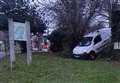 Residents baffled as van left wedged in hedge near park pond