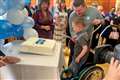 Daithi Mac Gabhann cuts cake on 75th anniversary of health service