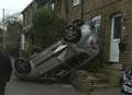 UPDATE: Car upside down after narrowly missing house