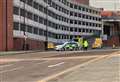 Police cordon off town car park after man falls from building