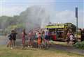 Firefighters cool down youngsters with a hose pipe