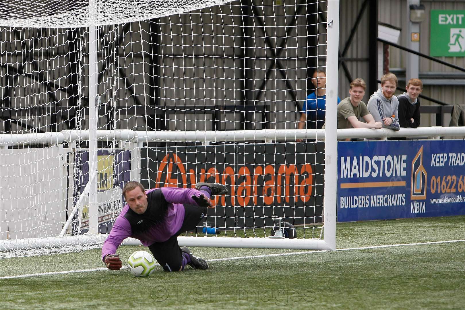 Grand Sports Club goalkeeper Mark Henderson saves in the shoot-out Picture: PSP Images