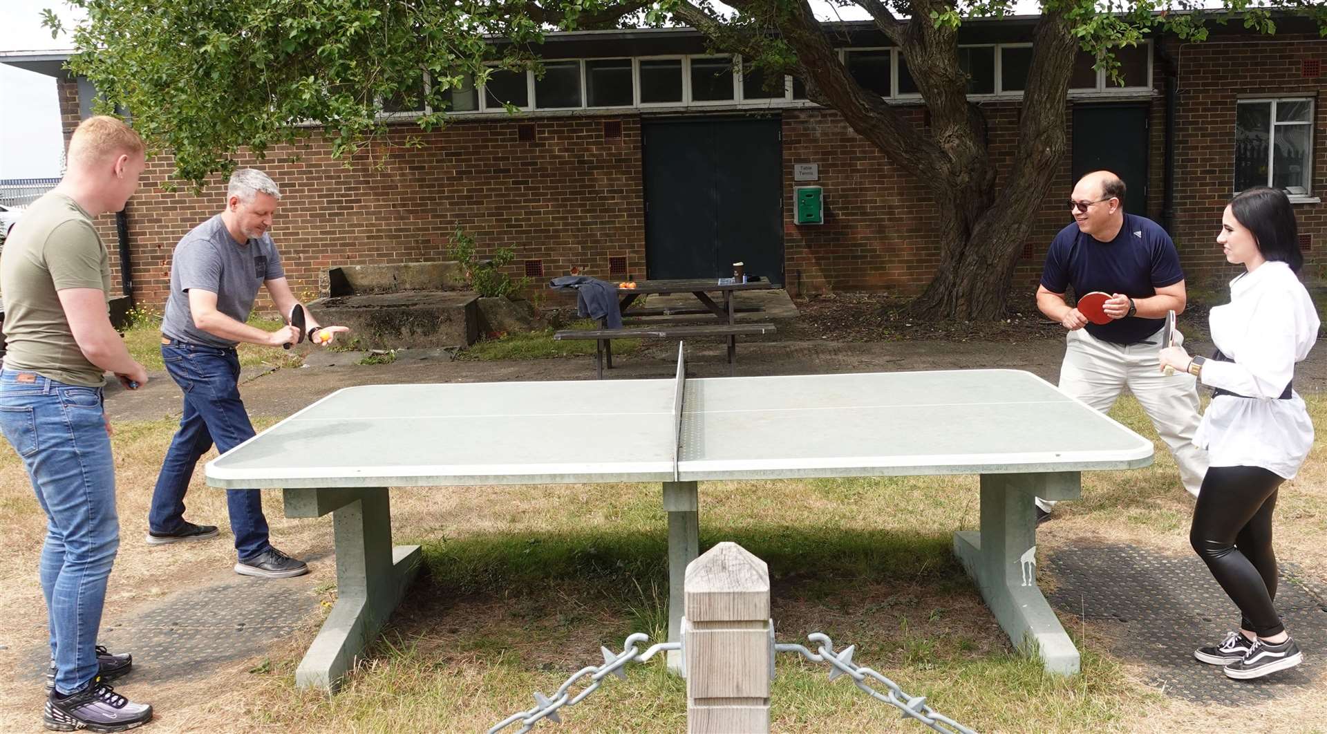 Employees enjoying a game of table tennis on site.