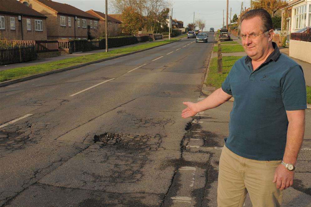 John Freeman with the crumbling road surface in The Broadway, Minster