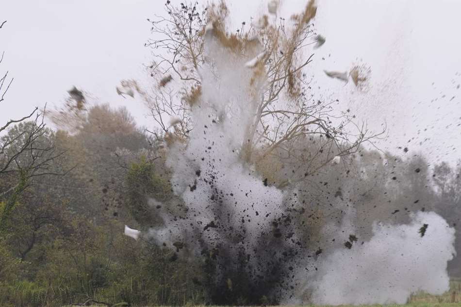 The explosion throws debris several feet into the air