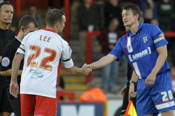 Callum Davies shakes hands with his former Gills team-mate Charlie Lee before kick-off