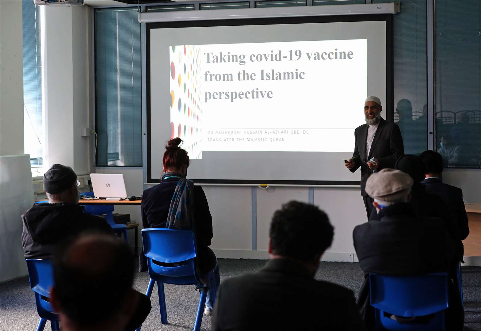 Members of the Muslim community learn about the benefits of having the Covid-19 vaccine (Peter Byrne/PA)