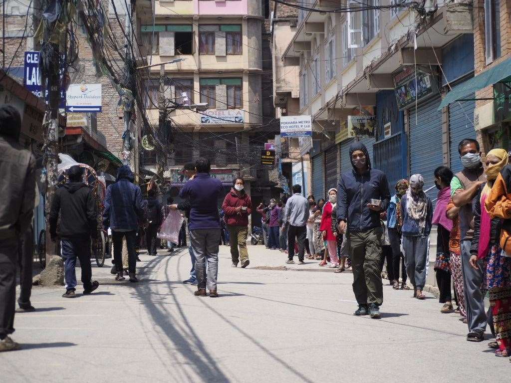 People queue for hot meals from Lockdown Lunches in Kathmandu. Picture: Richard Bayfield