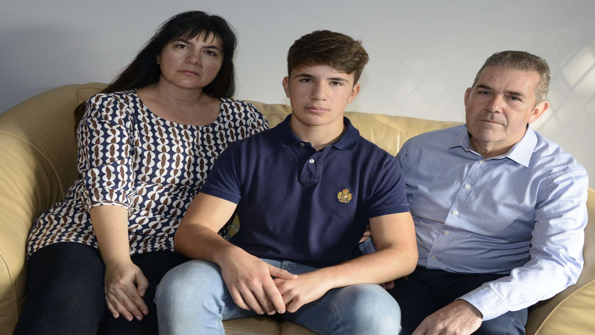 Christian Mason, 16, with his parents Donald and Vinka who are upset he cannot study chosen A- levels