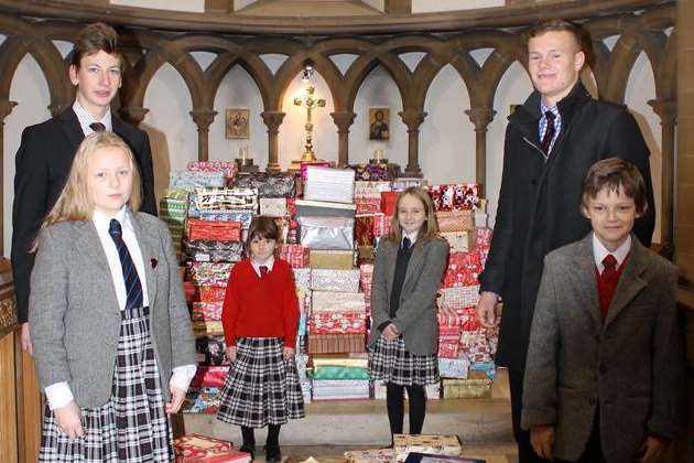 Dover College pupils Juliette Jordan, Titus Fischer, Scarlett Byrne, Millie Smith, Carl Koelln, and Thomas Wiggins in the Chapel with their Love In A Box donations.
