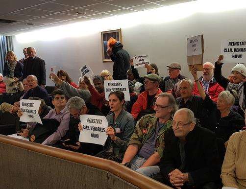 The public protest inside the council chamber - people in this photo have not been accused of the assault