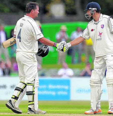 Rob Key is congratulated by Simon Cook after reaching his century against Surrey