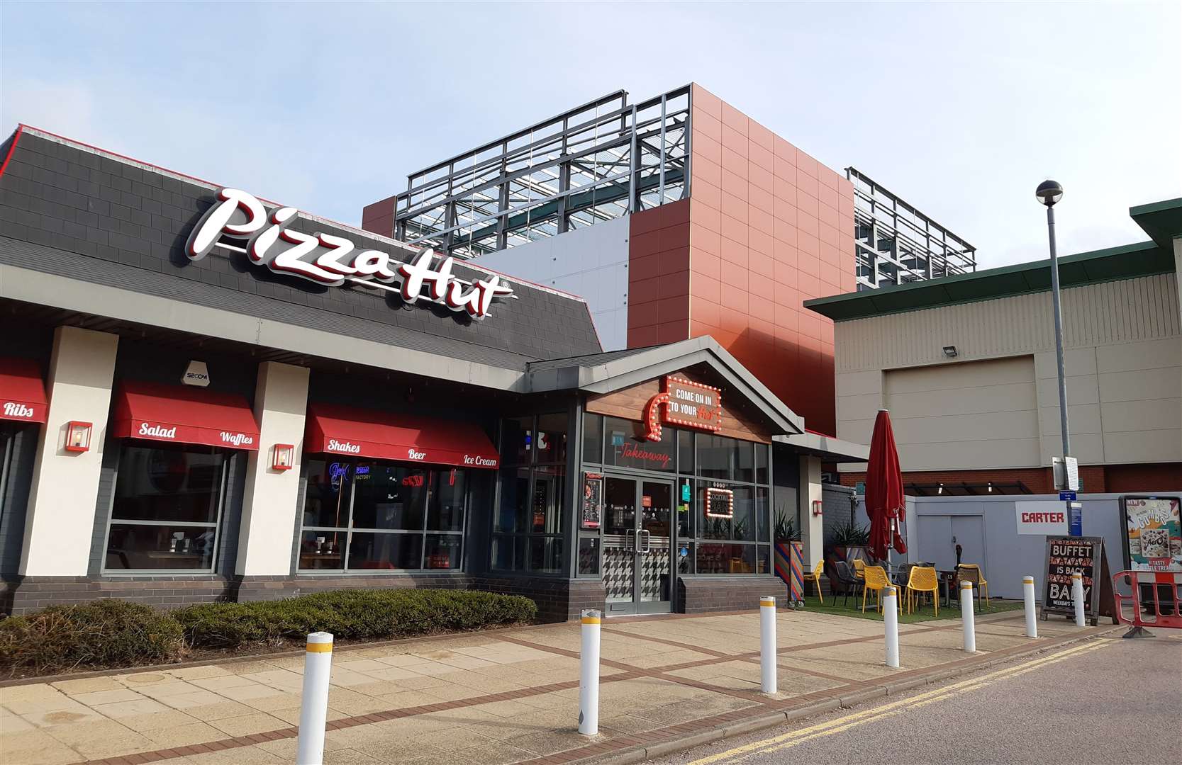 The new extension towers over Pizza Hut