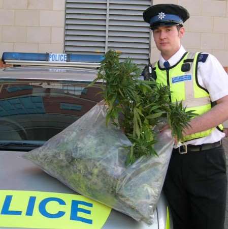 PCSO Marcus West with some of the seized plants
