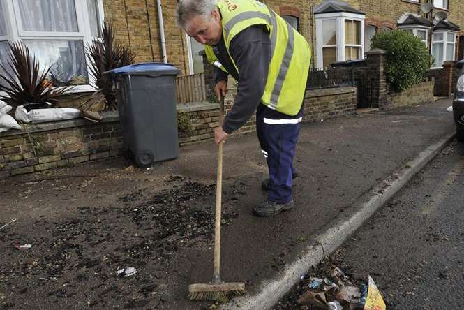 Hugh McCaughan, from Veolia, clearing up mess from flooding in Albert Road, Deal. Picture: Tony Flashman