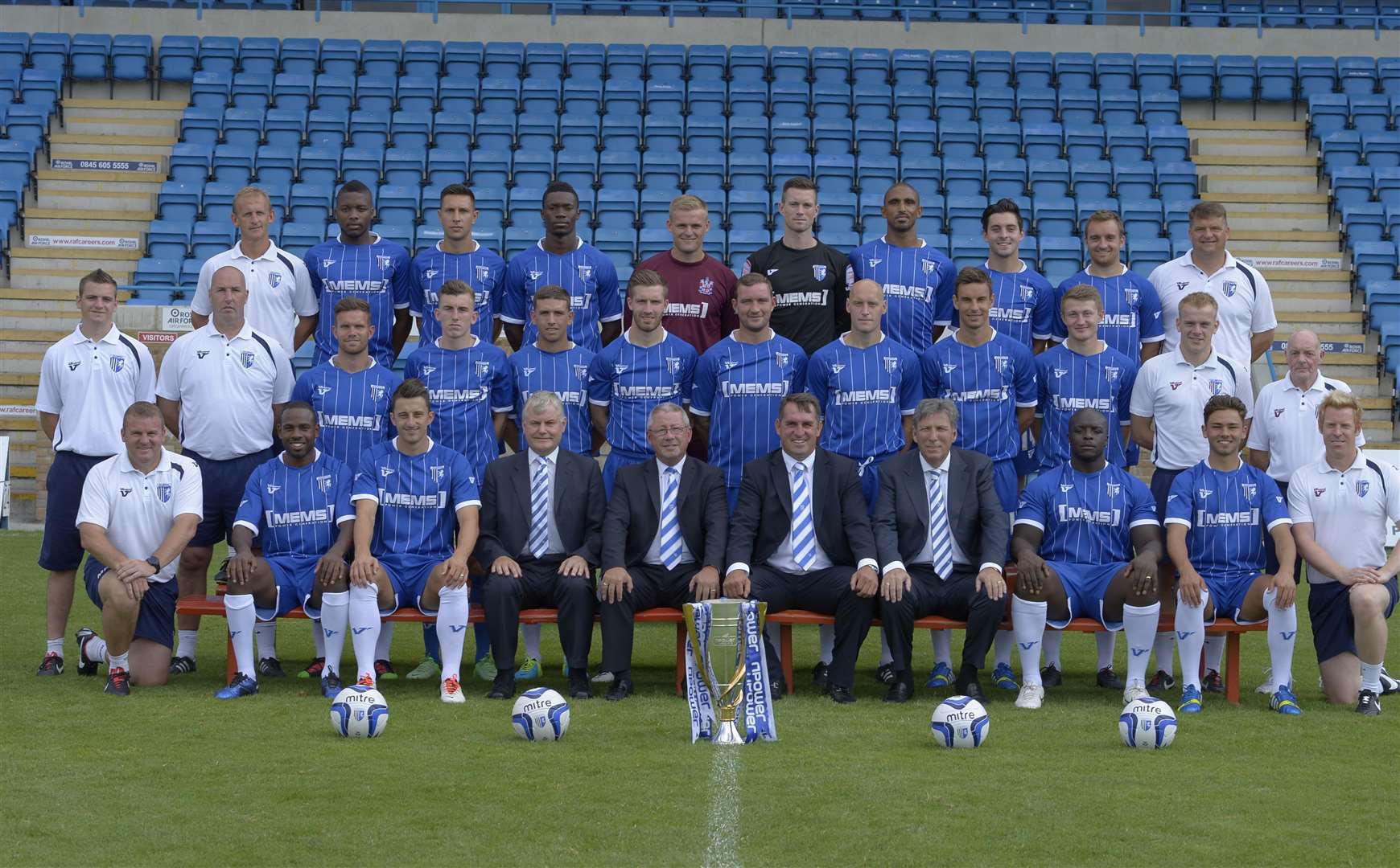 As Gillingham line up for the squad photo ahead of the 2013/14 season, Darren Hare, now a Faversham coach, is back row, far right and Adebayo Akinfenwa is front row, third from right. Picture: Andy Payton