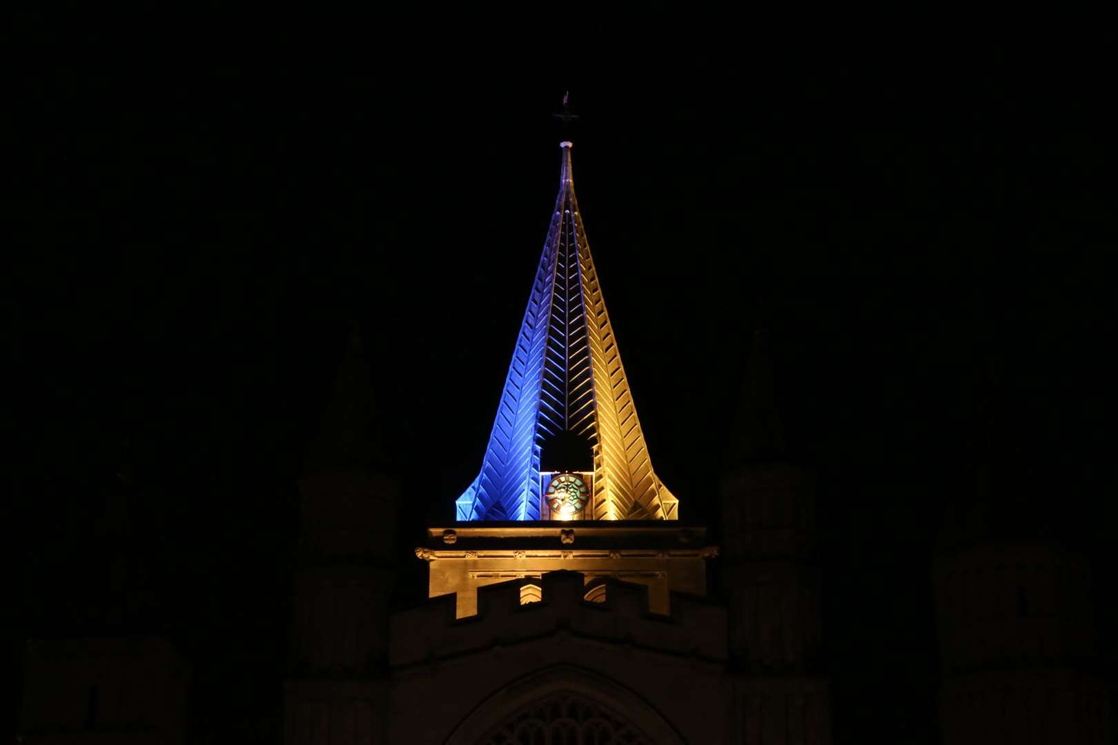 The spire at Rochester Cathedral has been turned yellow and blue to show support for Ukraine. Picture: Twitter/@RochesterCathedral