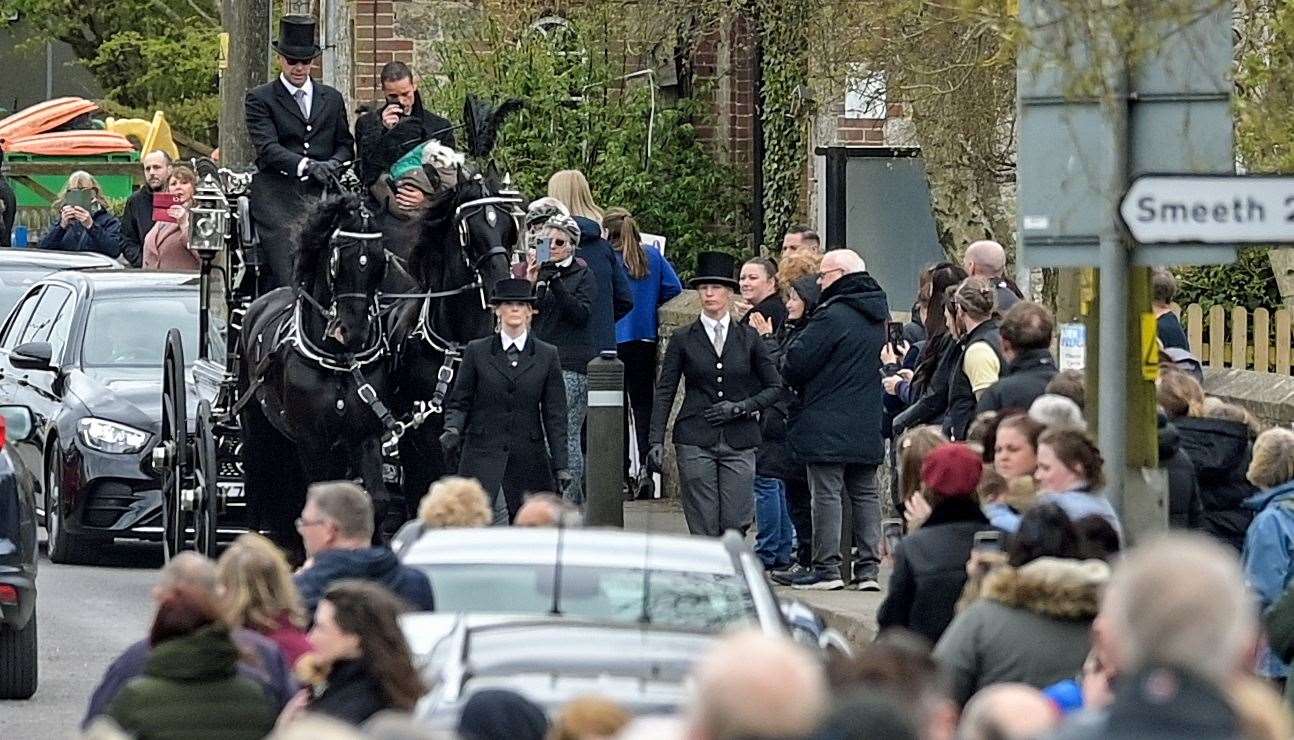 The funeral procession moves through Aldington village and down past the Walnut Tree public house. Picture: Stuart Brock