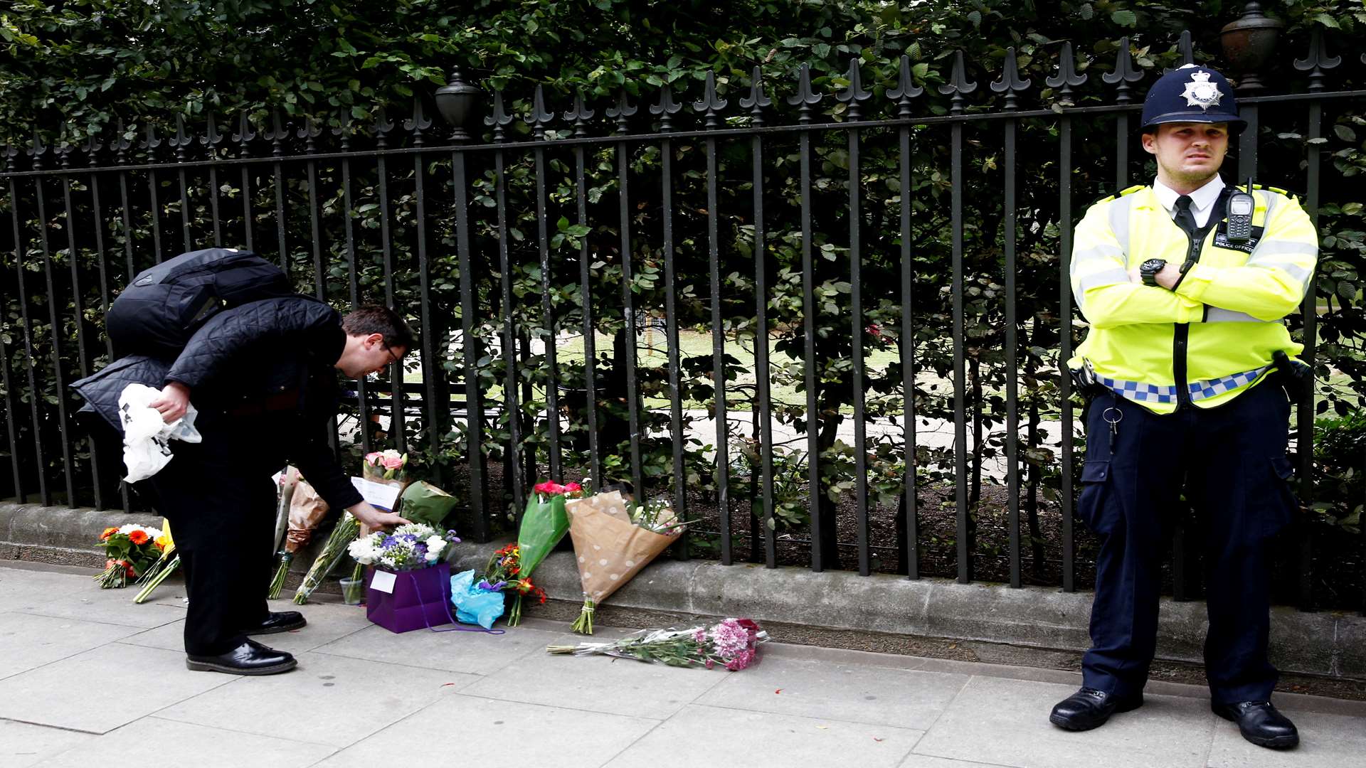 A man places flowers at the scene of the attack