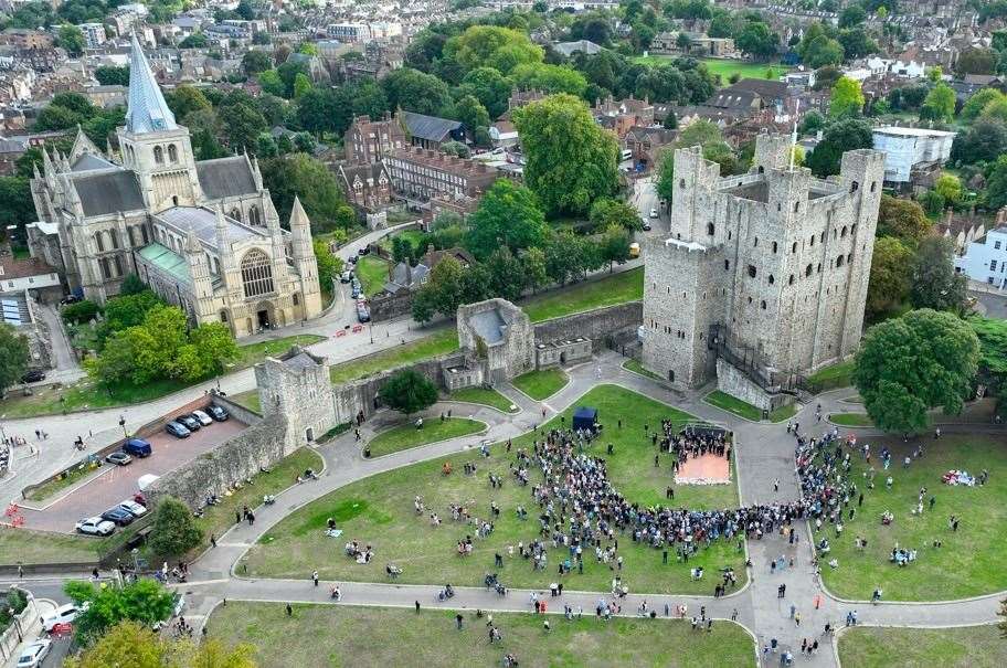 People watch and lay flowers at Rochester Castle for the proclamation of the new King. Picture: Medway Council