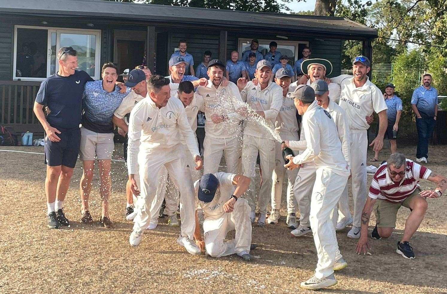 St Lawrence & Highland Court's first-team get the celebrations under way as they mark their return to the Kent League Premier Division for the first time in 12 years