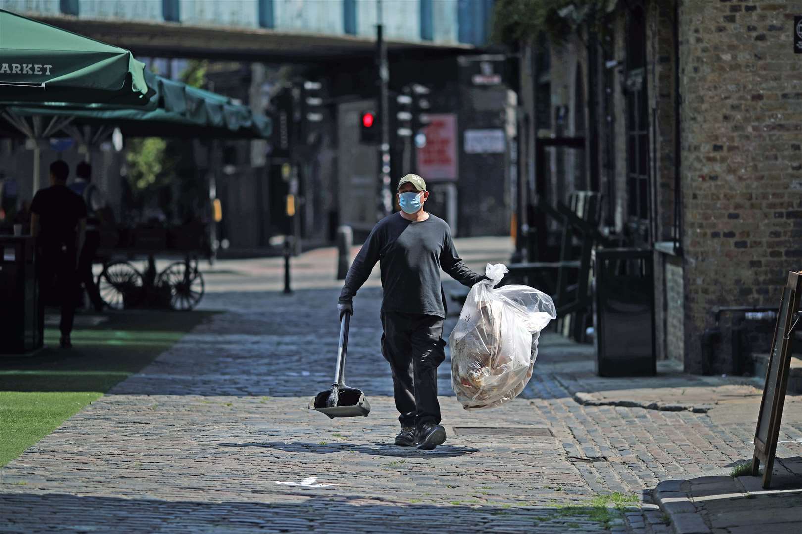 A street cleaner at Camden Market (Aaron Chown/PA)