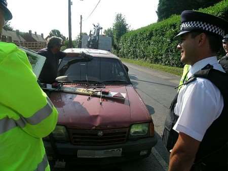 Police removing untaxed car from a Kent street during earlier operation