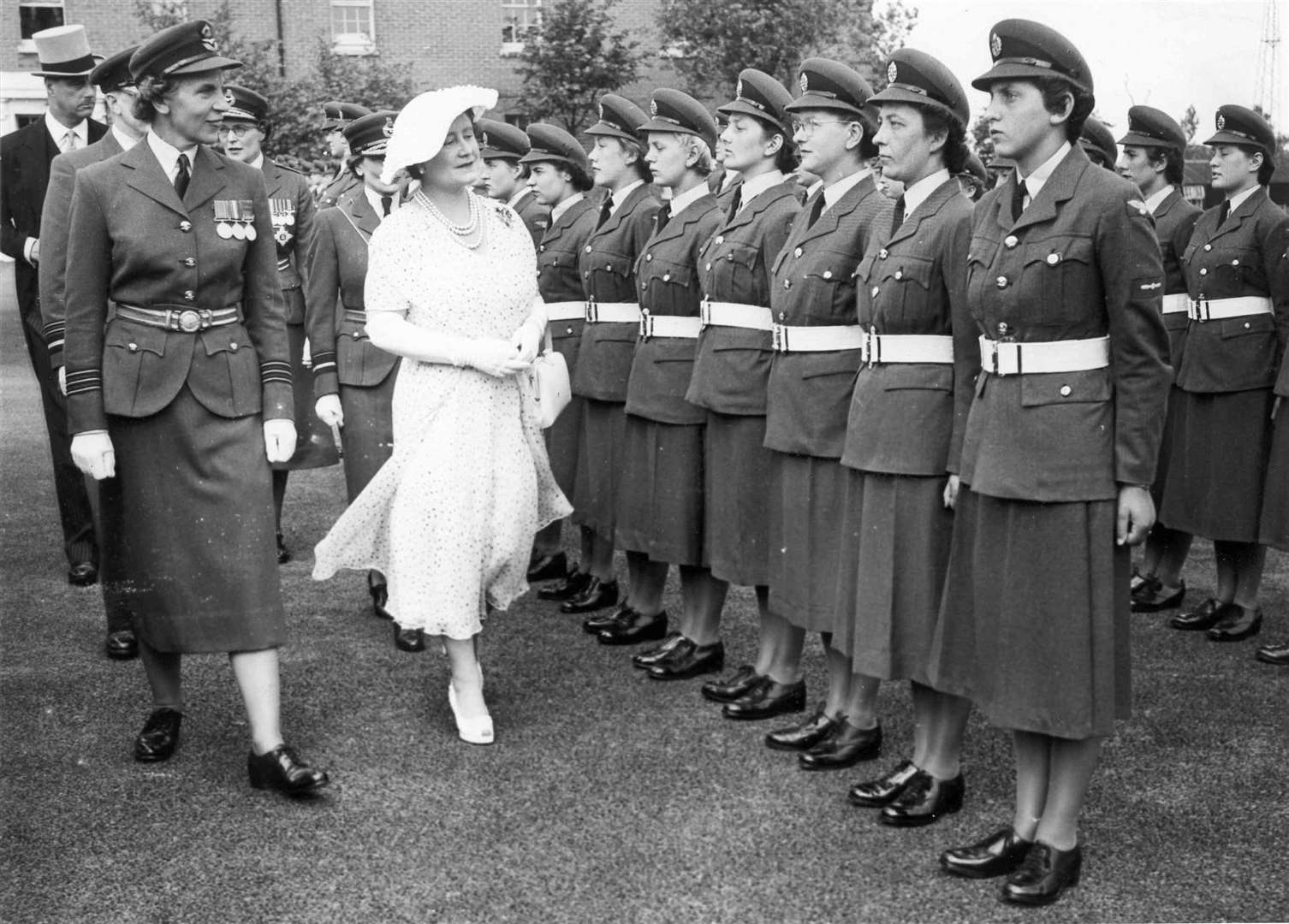 The Queen Mother and the Duchess of Gloucester spent four hours touring the WRAF Station at Hawkinge in July 1955. Among the cadets they met were four pioneers of the Burmese Women's Air Force who were training at the site