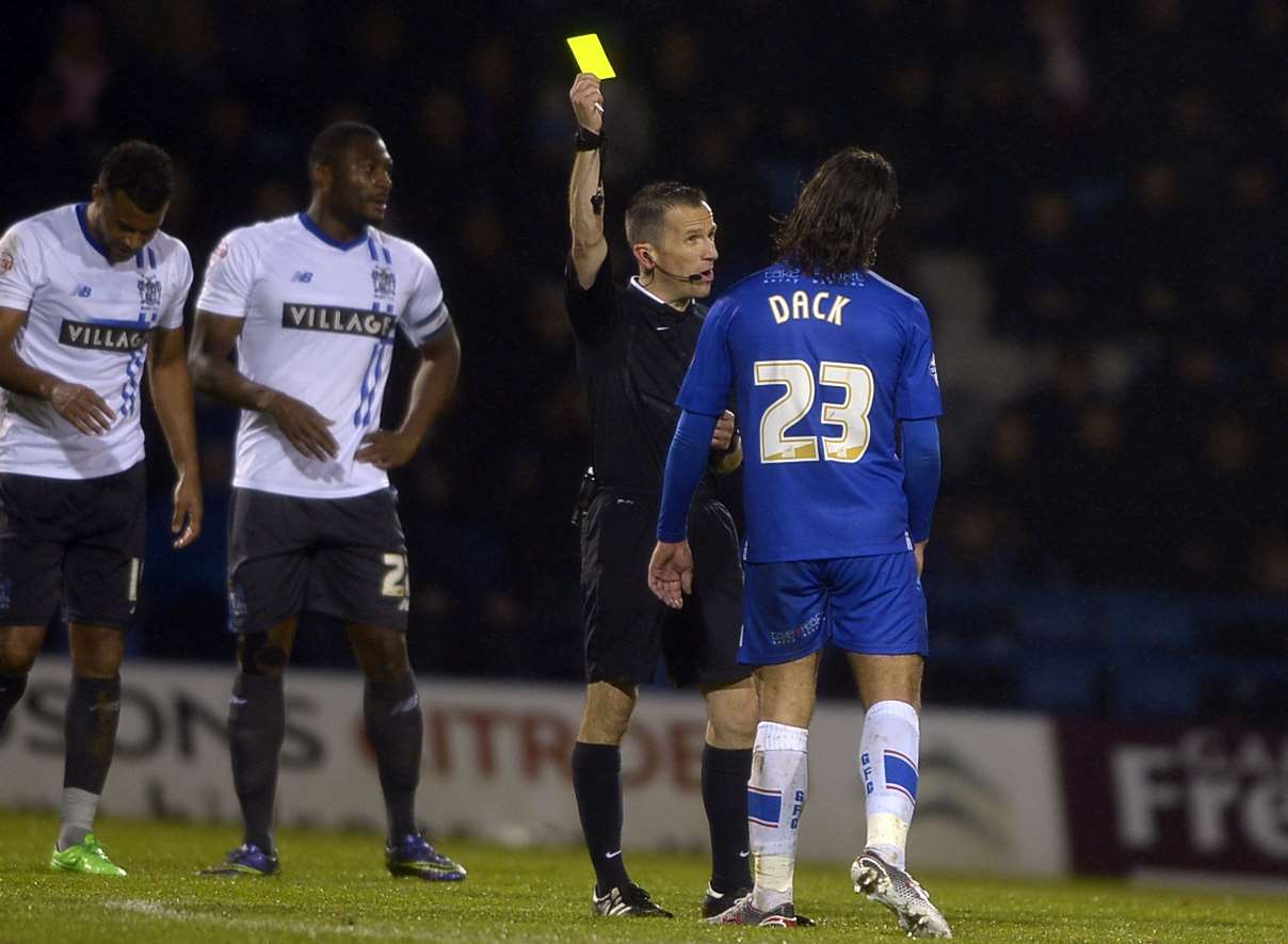Gills' Bradley Dack is booked against Bury last month. Picture: Barry Goodwin