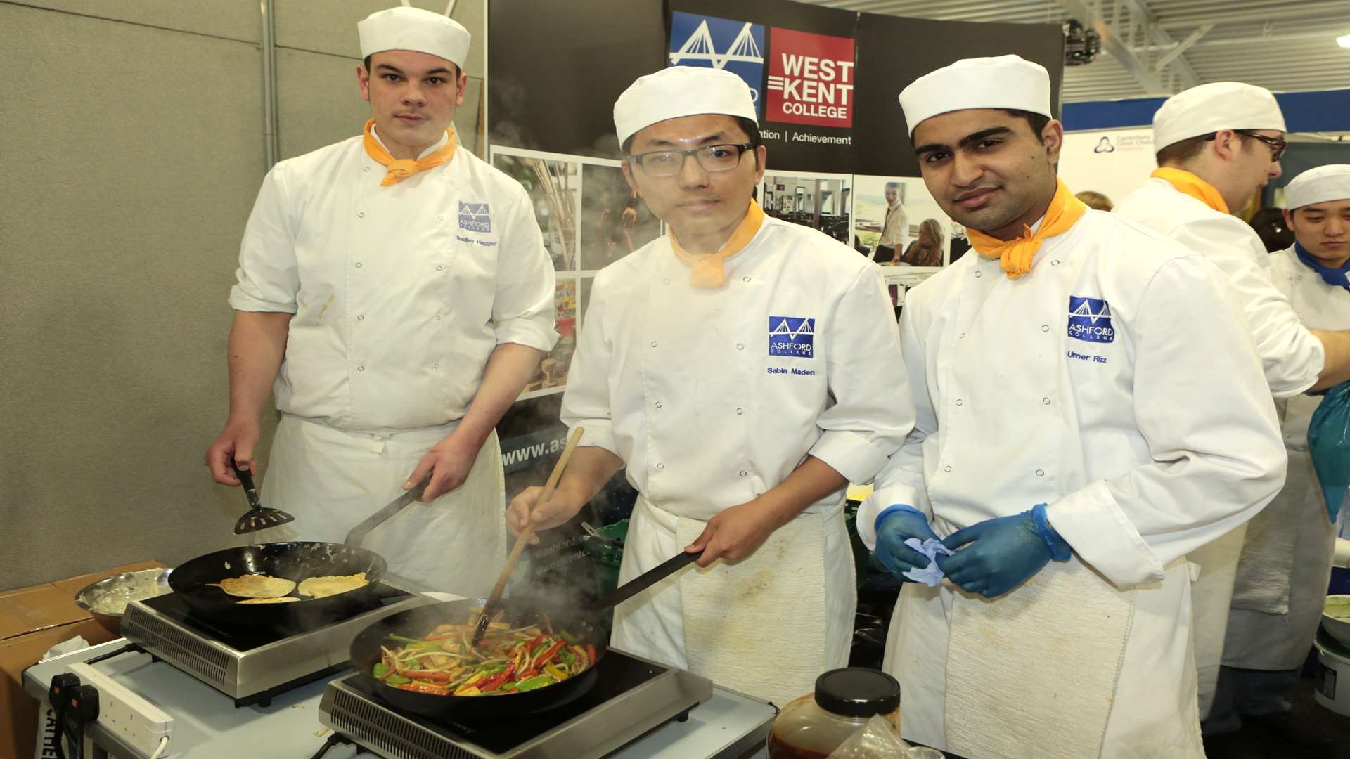 From left, Bradley Hagger, Sabin Maden and Umer Rlaz cook on the Ashford College stand
