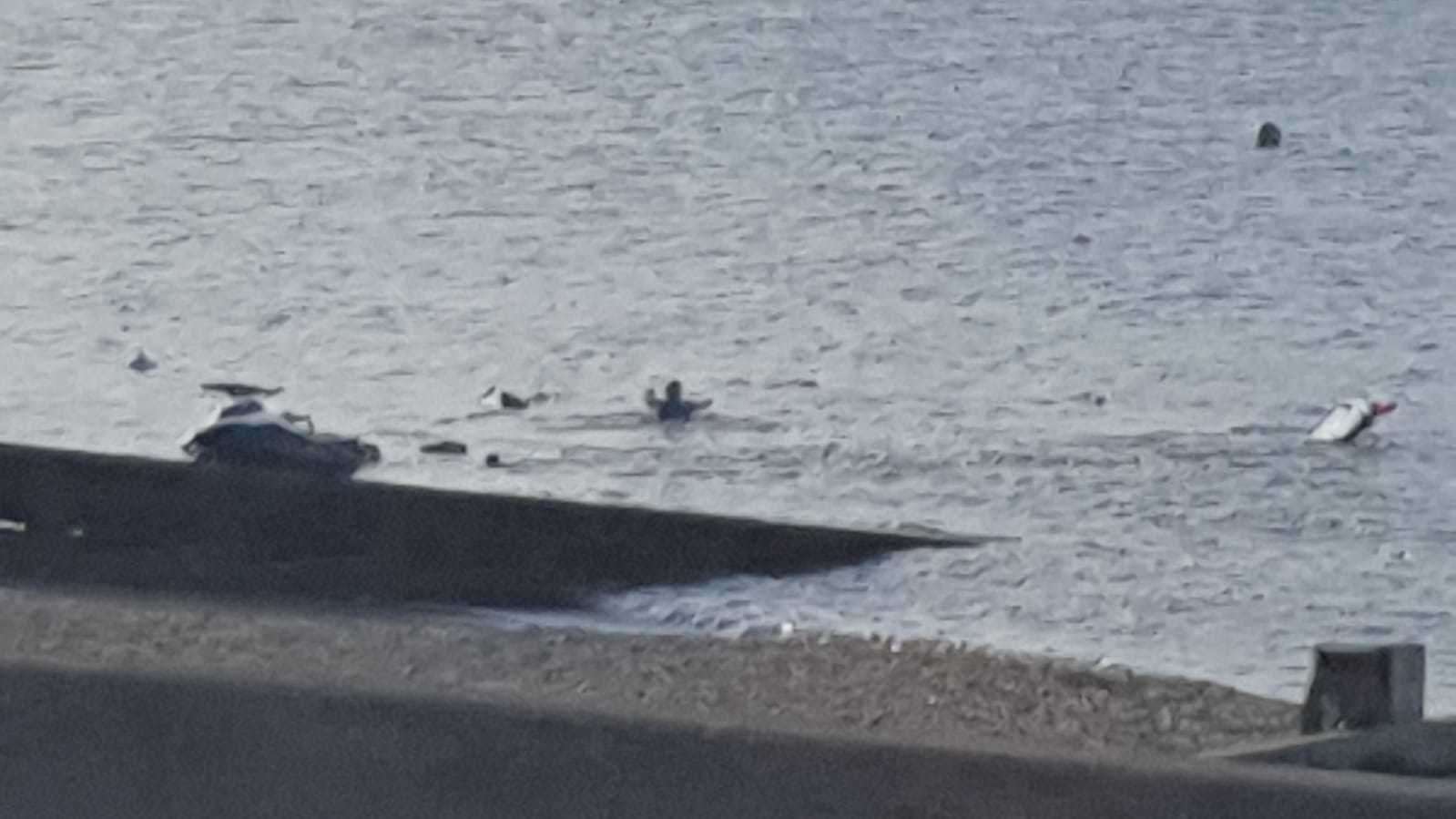 A person swimming out to the car