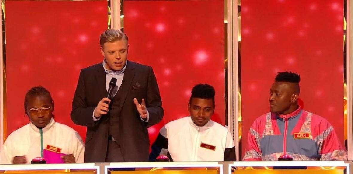 Comedian Rob Beckett finds out why Carreira 3 are still sitting down on BBC's All Together Now (7863676)