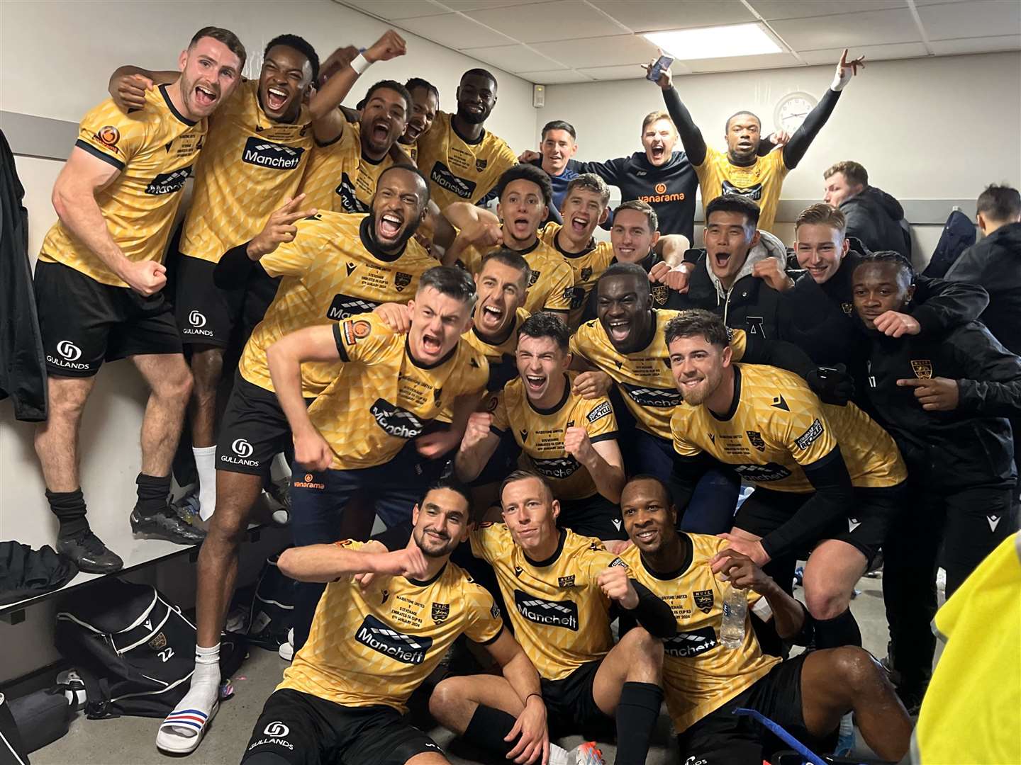 Maidstone United players celebrate in the dressing room after beating Stevenage. Picture: Steve Terrell