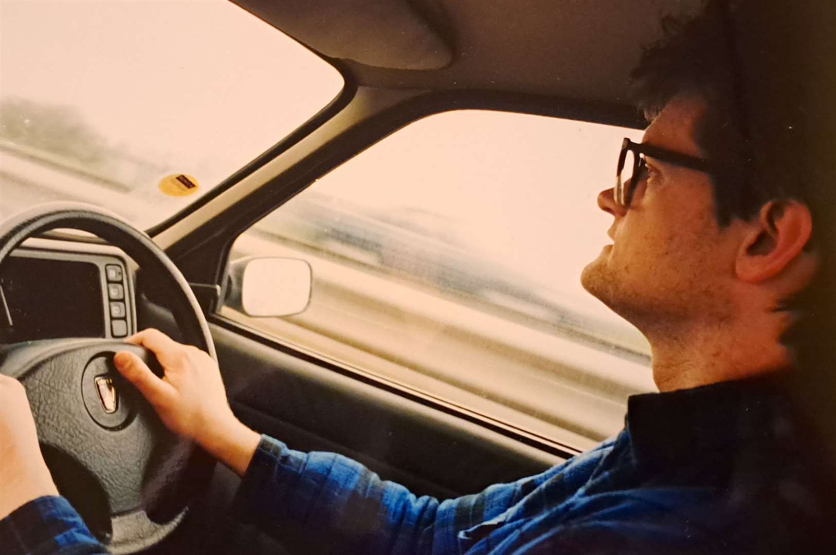 Reporter Sam Lennon driving a car in the 1990s after passing his test. Picture: Colin Mearns