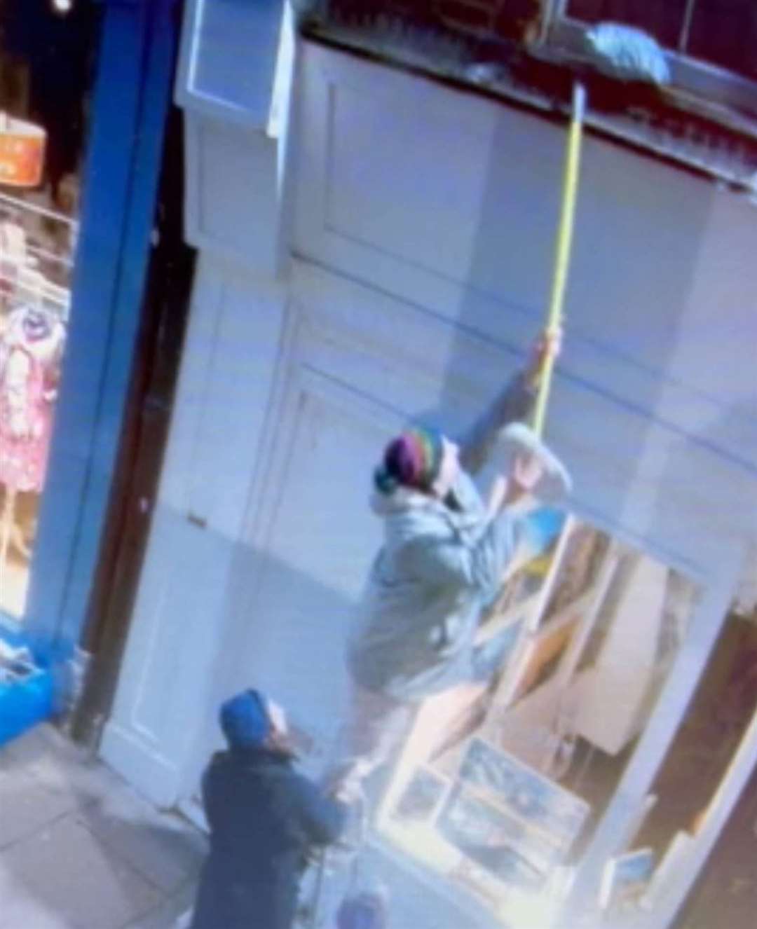 A group had to use a ladder and broom to retrieve the parcel