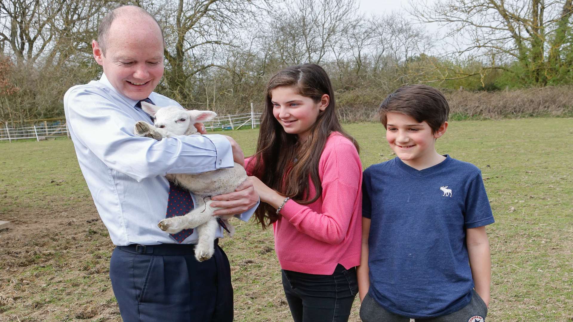 Lib Dem candidate Jasper Gerard shows his children Emilia and Fred how to hold a sheep