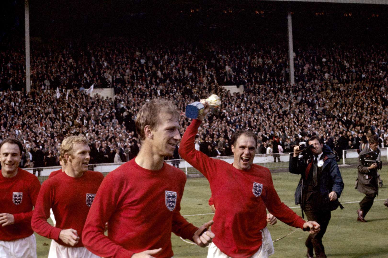 England’s George Cohen, Bobby Moore, Jack Charlton and Ray Wilson, with trophy, celebrate after winning the World Cup in 1966 (PA Archive)