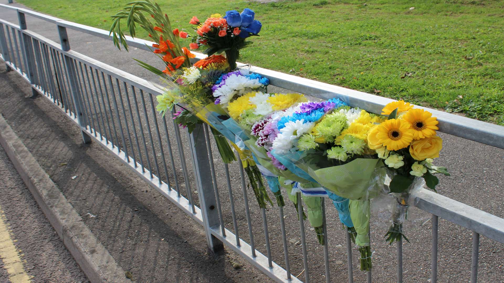 Bunches of flowers left at the spot where a cyclist was knocked down by a lorry in Gillingham